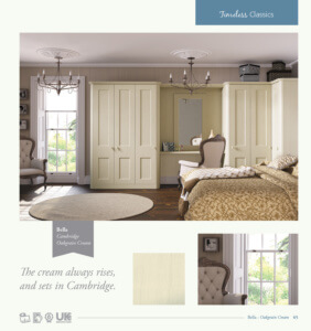 A bedroom with cream-colored wardrobes and furniture, including a bed with a cushioned headboard and a vanity table with an ornate mirror. The room features a large window with garden views and elegant ceiling chandeliers.